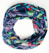 Load image into Gallery viewer, Travel scarf featuring hidden pocket in a navy tropical print