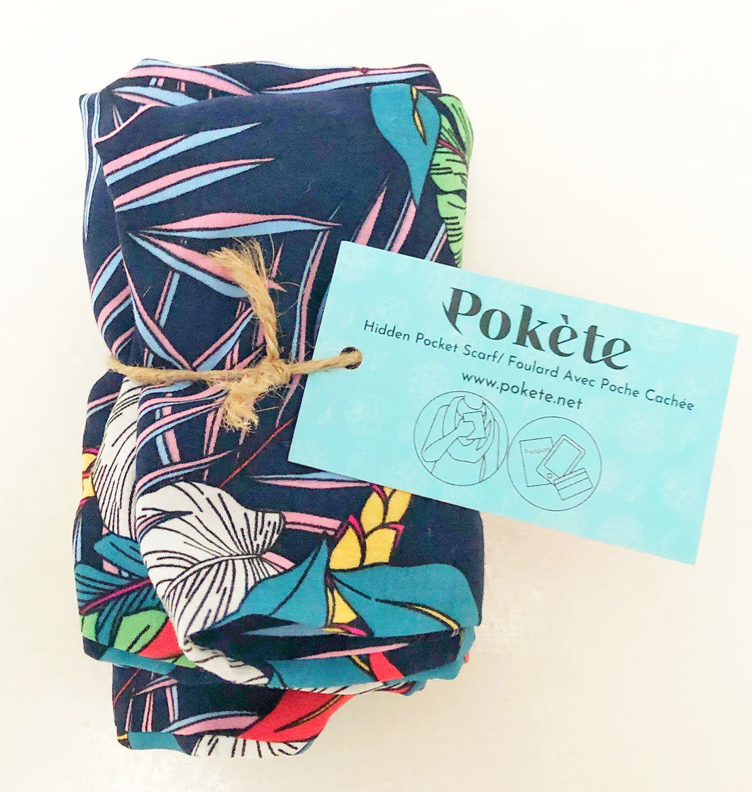 Travel scarf featuring hidden pocket in a navy tropical print